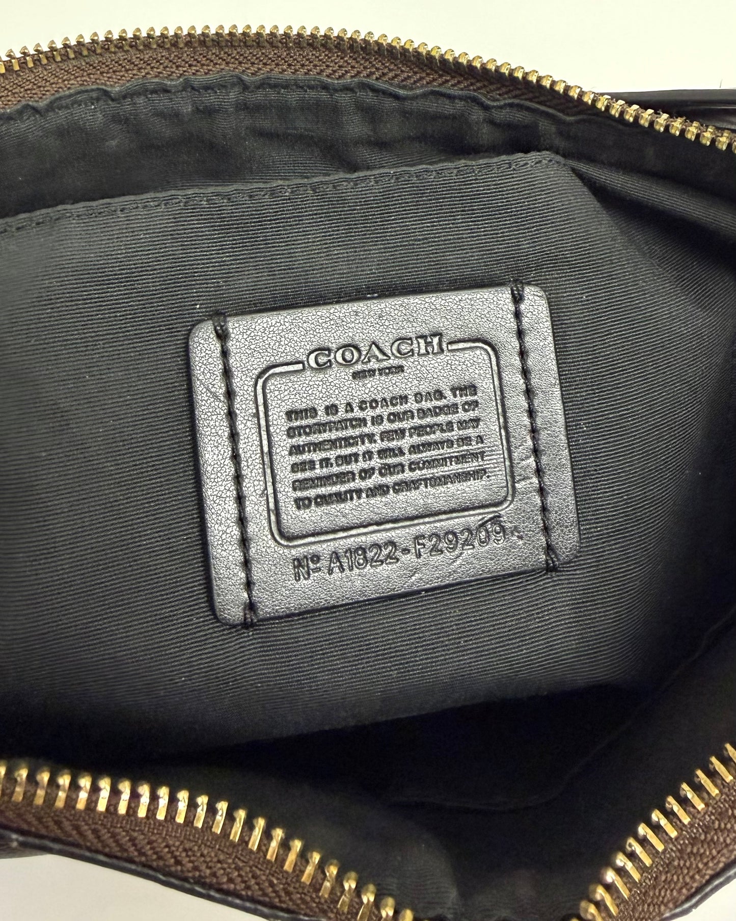 Coach Laurel Shoulder Bag in a dark brown Signature coated canvas with black leather trim and a gold-toned logo