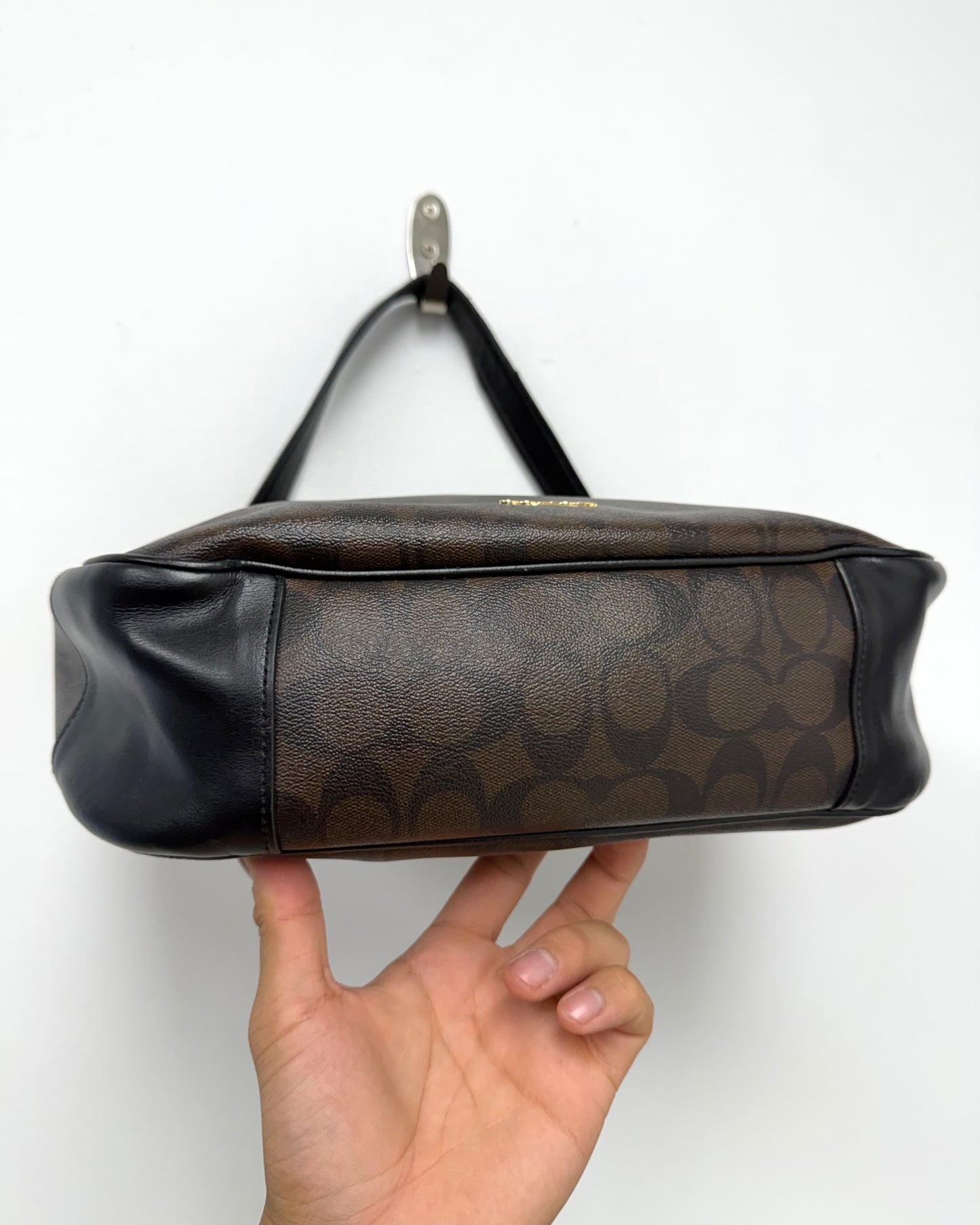 Coach Laurel Shoulder Bag in a dark brown Signature coated canvas with black leather trim and a gold-toned logo