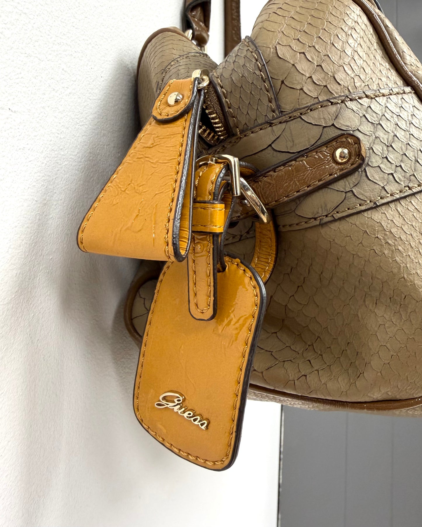 tan snakeskin-textured Guess satchel