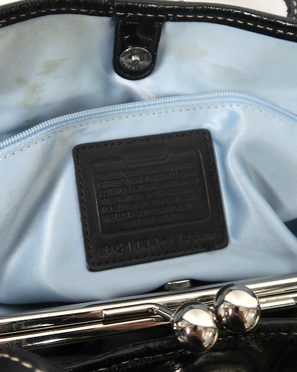 black patent leather Coach Signature Stitch Carryall